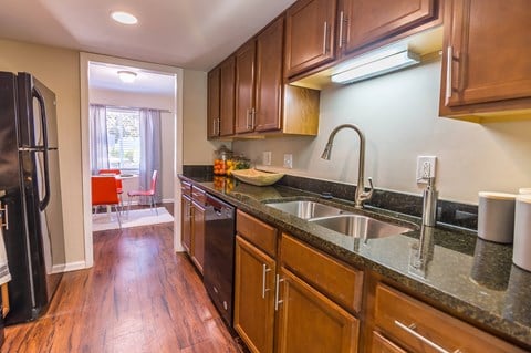 a kitchen with wood cabinets and granite countertops